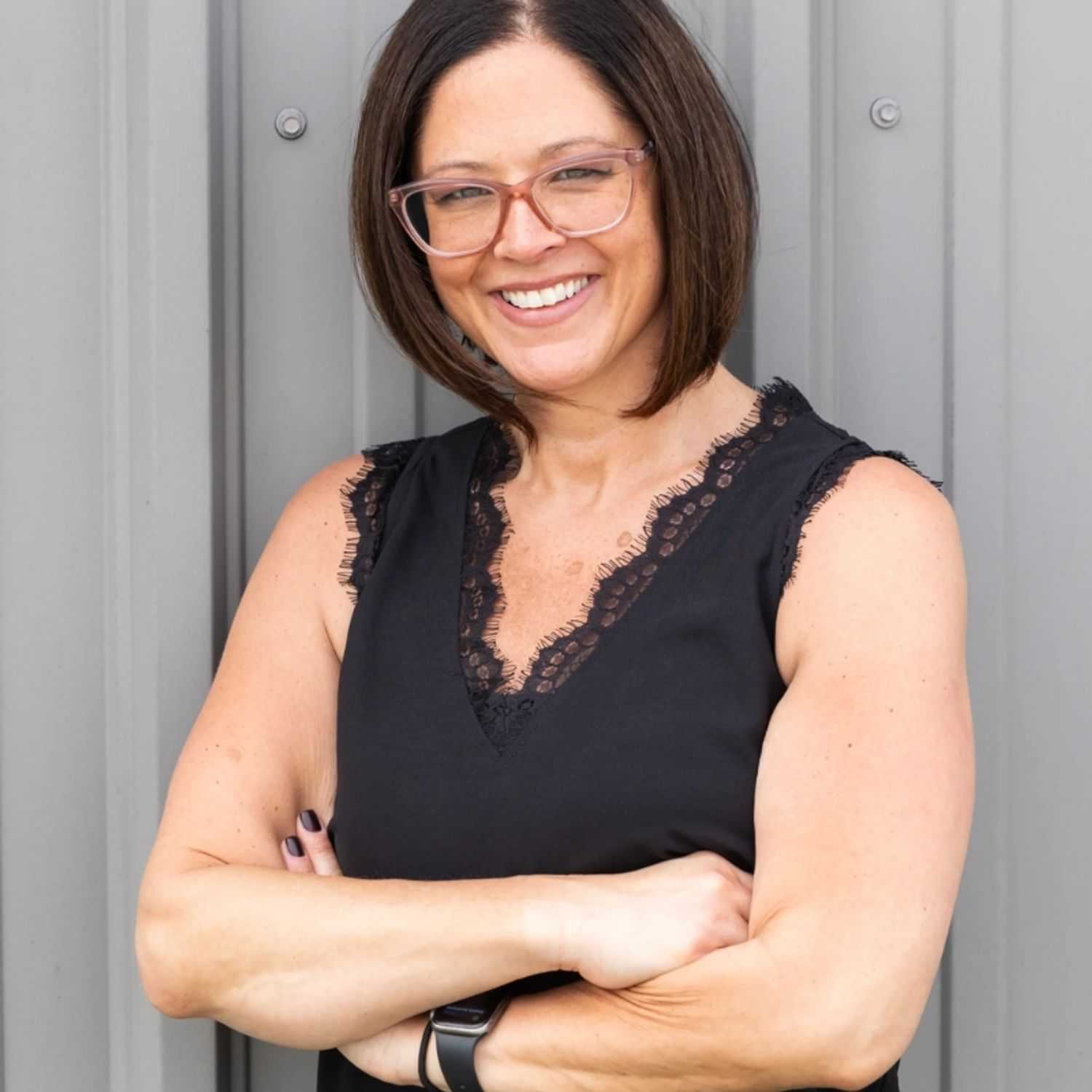 Portrait of Nicole, a professional stylist at Revolutions Salon, showcasing their expertise and style.