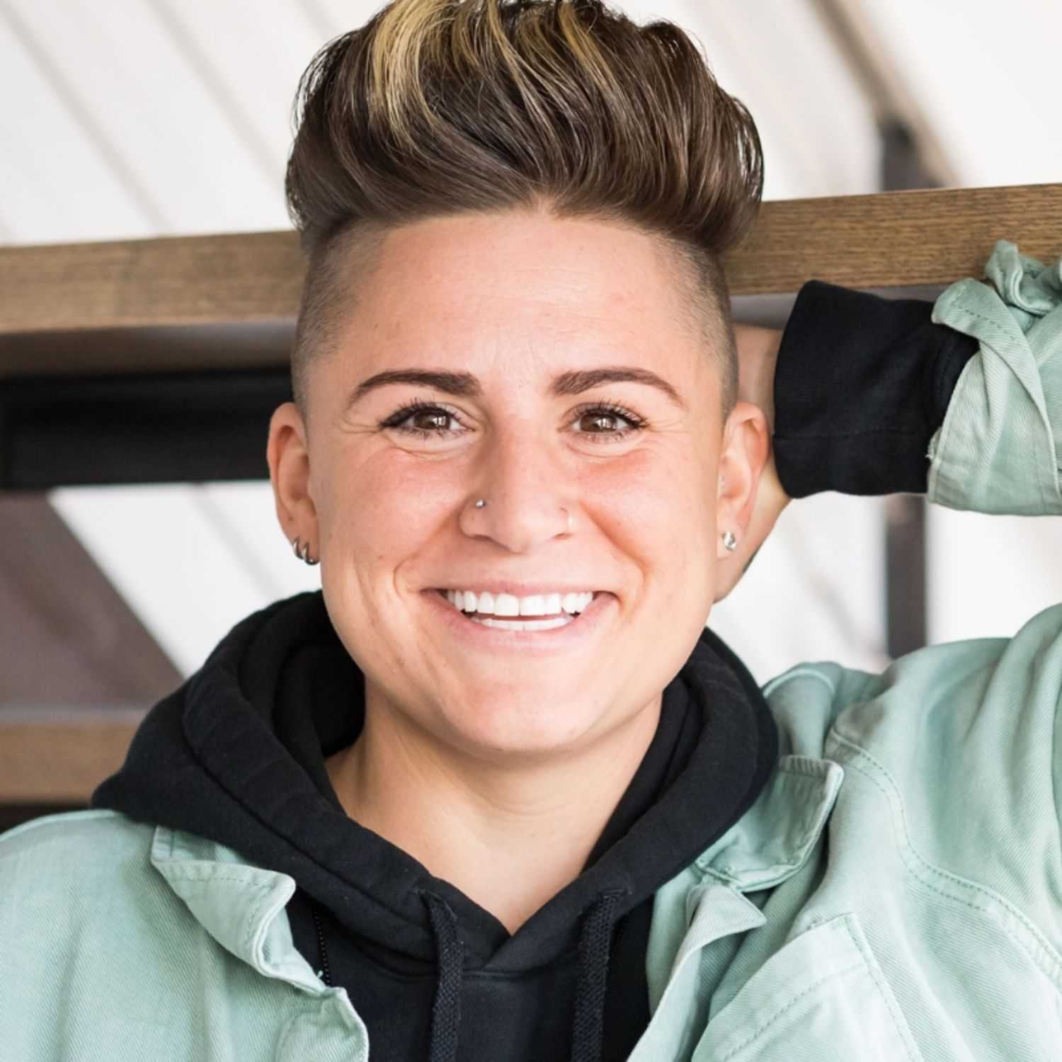 Portrait of Jess, a professional stylist at Revolutions Salon, showcasing their expertise and style.