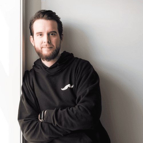 Portrait of Jon, a professional stylist at Revolutions Salon, showcasing their expertise and style.