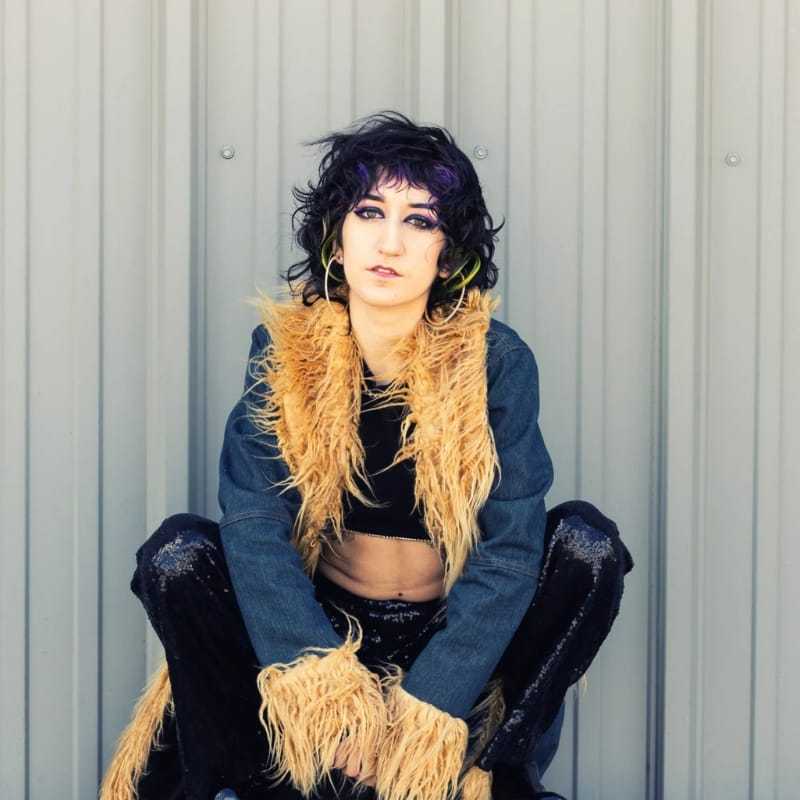 Portrait of Victoria, a professional stylist at Revolutions Salon, showcasing their expertise and style.