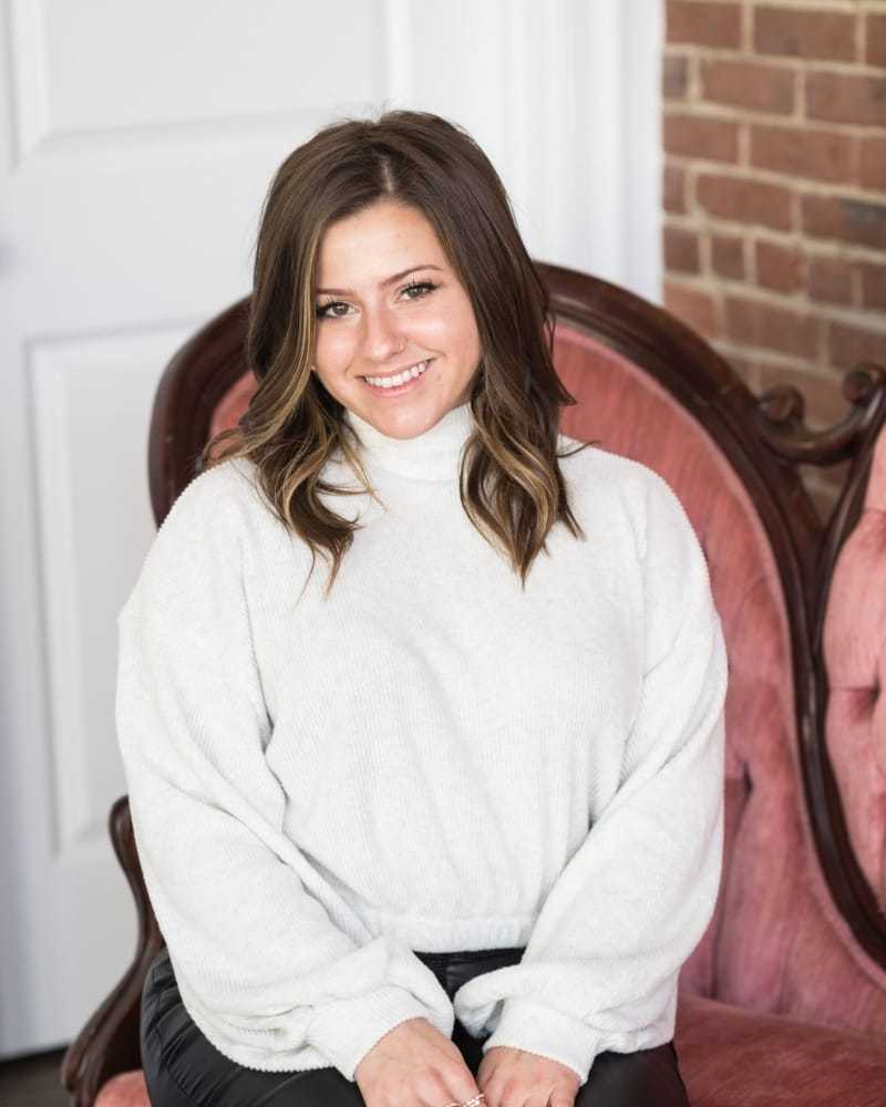 Portrait of Rachel, a professional stylist at Revolutions Salon, showcasing their expertise and style.