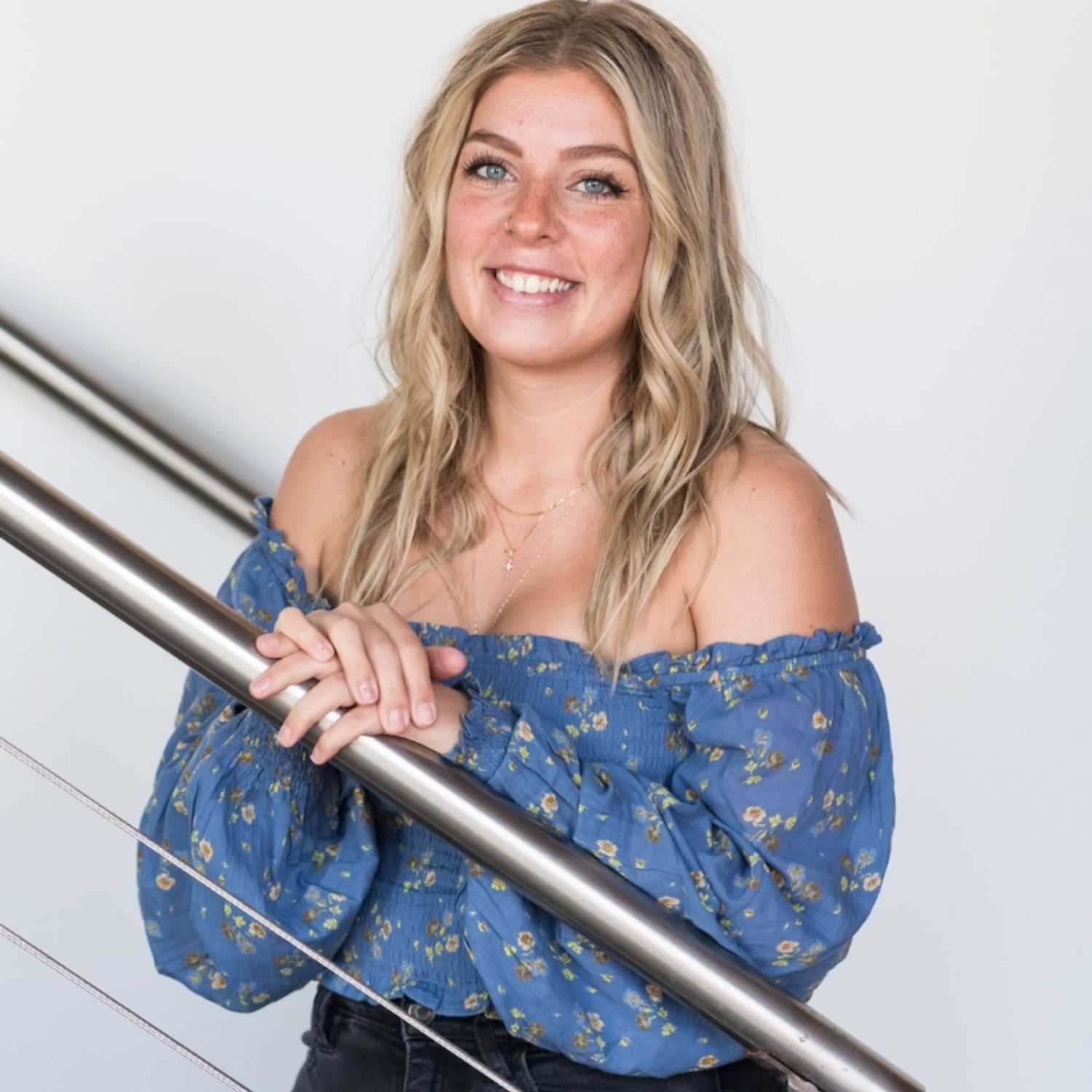 Portrait of Destinee, a professional stylist at Revolutions Salon, showcasing their expertise and style.