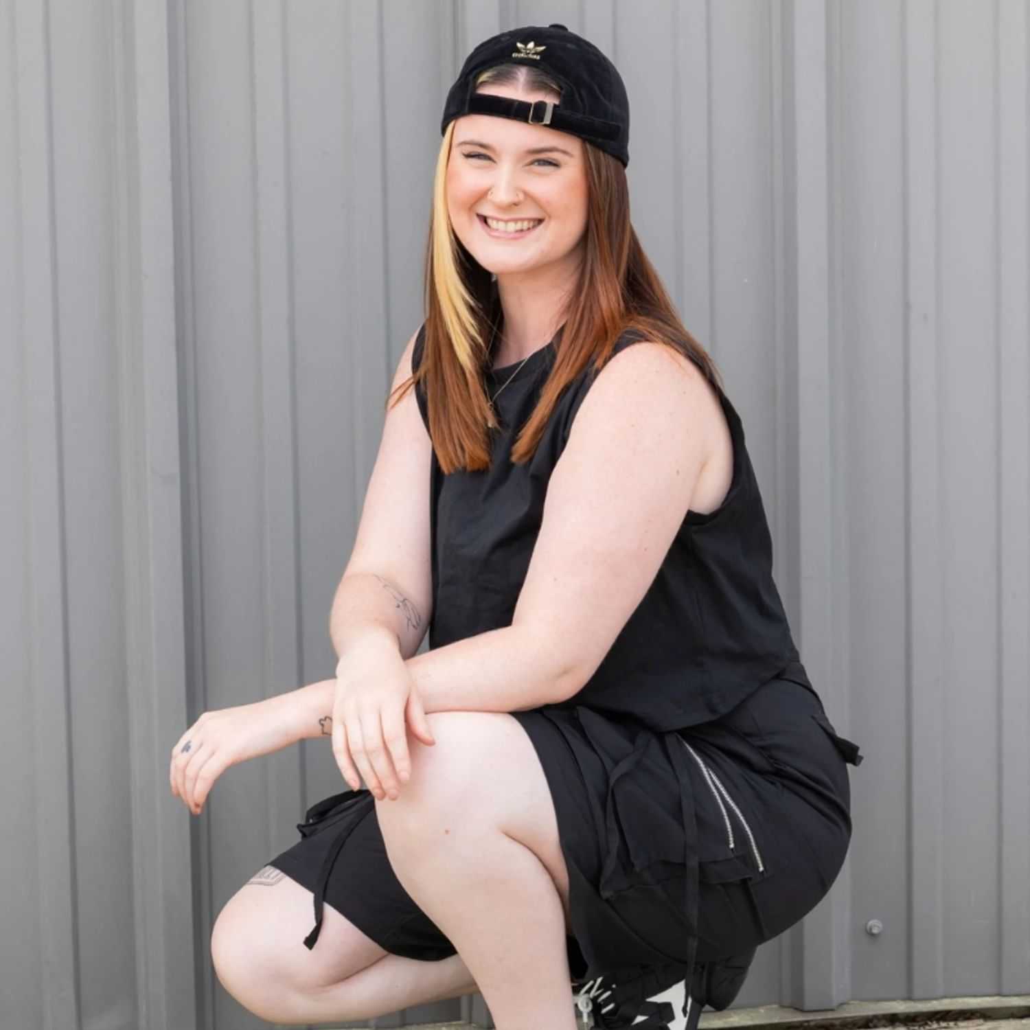 Portrait of Micayla, a professional stylist at Revolutions Salon, showcasing their expertise and style.