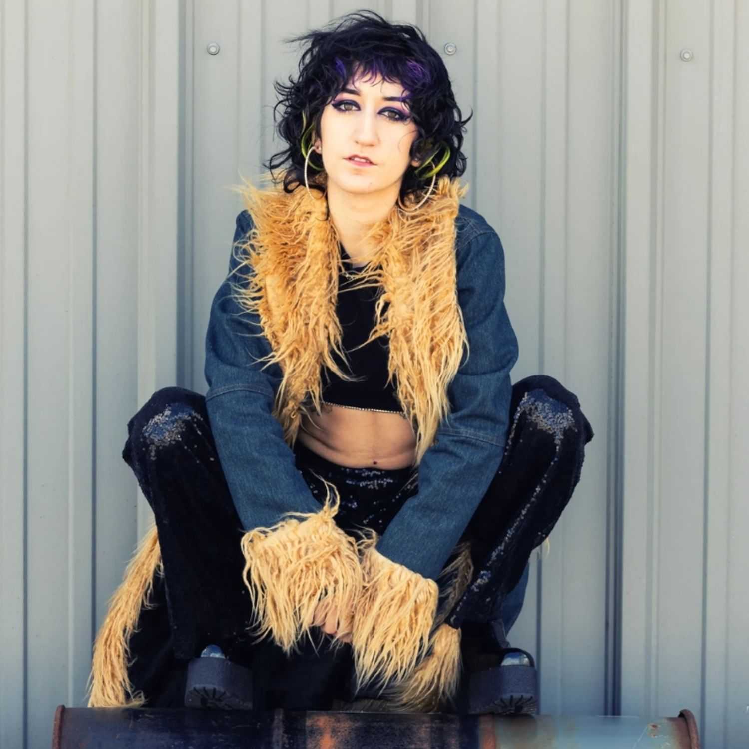 Portrait of Victoria, a professional stylist at Revolutions Salon, showcasing their expertise and style.