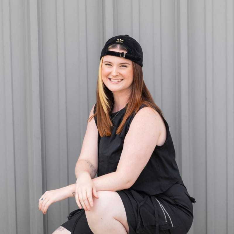 Portrait of Micayla, a professional stylist at Revolutions Salon, showcasing their expertise and style.