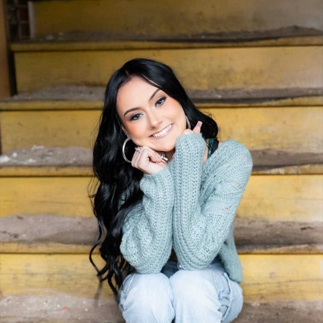 Portrait of Julia, a professional stylist at Revolutions Salon, showcasing their expertise and style.