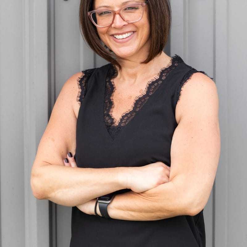 Portrait of Nicole, a professional stylist at Revolutions Salon, showcasing their expertise and style.