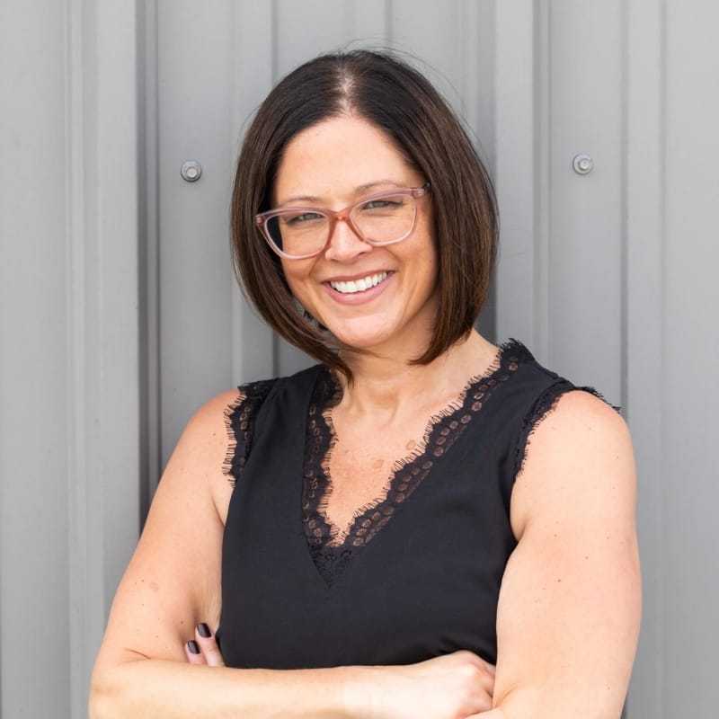 Portrait of Nicole, a professional stylist at Revolutions Salon, showcasing their expertise and style.